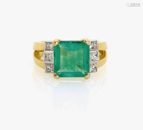 AN EMERALD AND DIAMOND SET RING England, 1990s-2000s