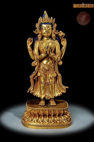 A MING DYNASTY BRONZE GILT FOUR-ARMED GUANYIN STATUE