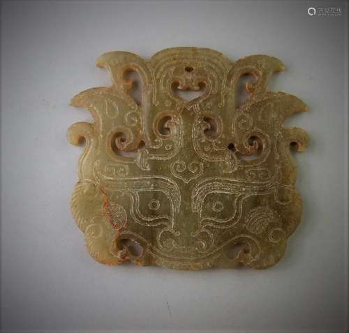 A Chinese archaic jade carved beast mask design pendant