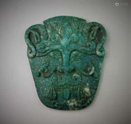 A Chinese archaic tian-he jade caved beast mask design pendant