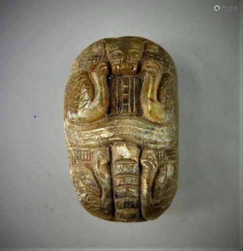 A Chinese archaic jade carved beast mask design pendant