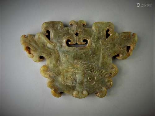 A Chinese archaic jade carved beast mask design pendant