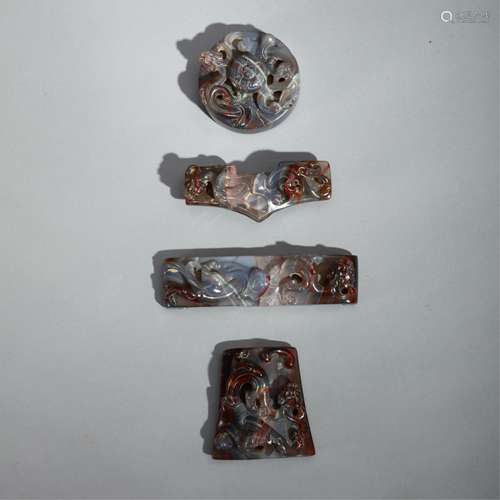 FOUR CHINESE JADE CARVED SWORD FITTINGS