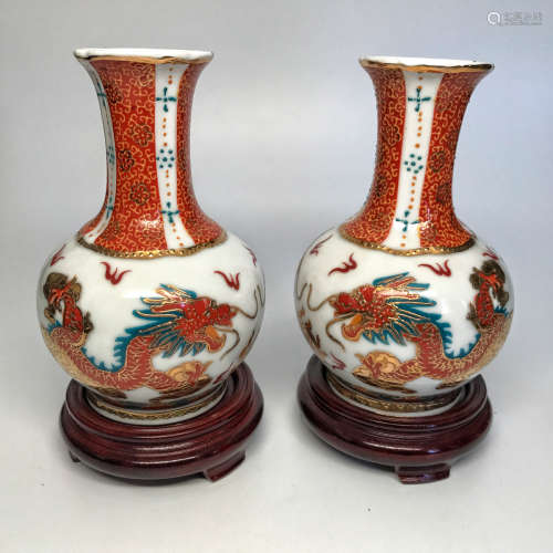 A PAIR OF DRAGON PATTERN MULTI-COLORED VASES WITH PEDESTAL