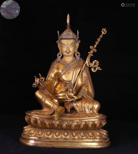 A TIBETAN GILT BRONZE MOLDED BUDDHA STATUE