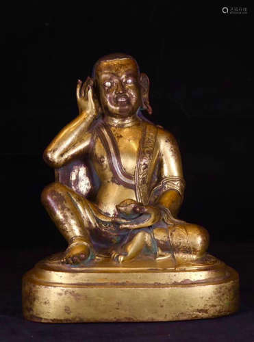 A TIBETAN GILT BRONZE MOLDED BUDDHA STATUE