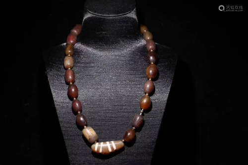 A OX HORN AND DZI BEAD STRING NECKLACE