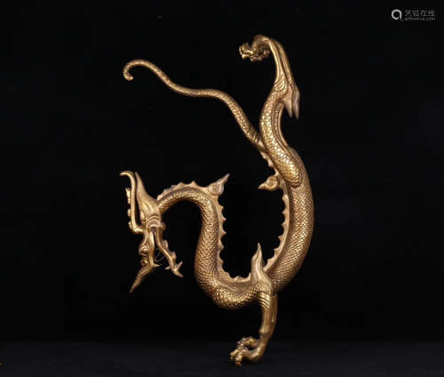 A GILT BRONZE 'S' SHAPED DRAGON ORNAMENT