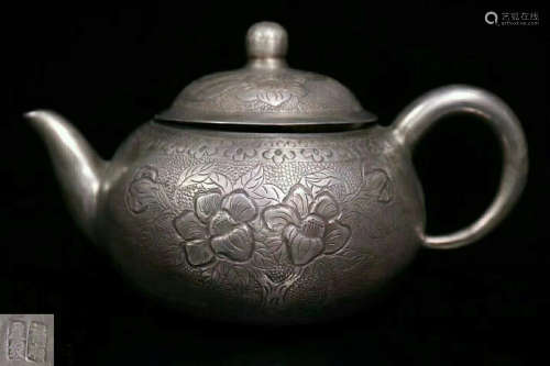 A SILVER TEAPOT