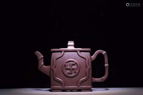 A PURPLE CLAY TEAPOT