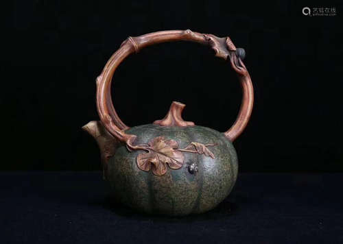 A MELON DESIGN LOOP-HANDLED PURPLE CLAY TEAPOT