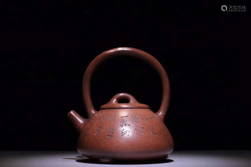 A PURPLE CLAY LOOP-HANDLED TEAPOT