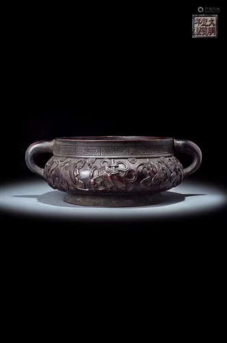 A MING DYNASTY BRONZE RELIEF EIGHT TREASURE PATTERN FURNACE