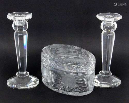 A BISCUIT TIN AND A PAIR OF CANDLESTICKS Crystal