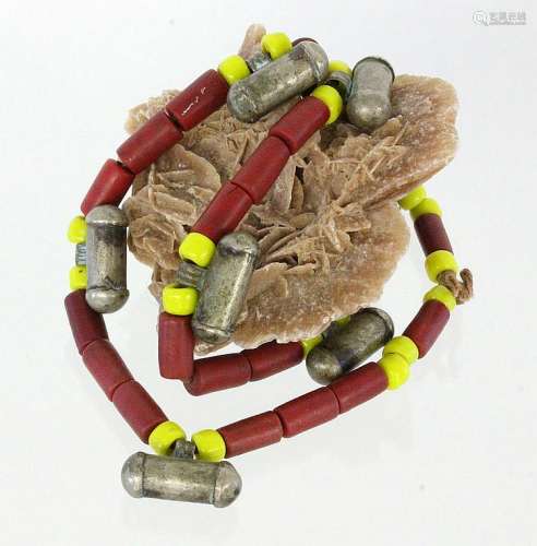 A NECKLACE with red stone, glass balls and metal