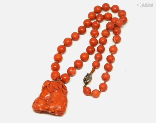 A String of Coral Bead with Carved Pendant Necklace