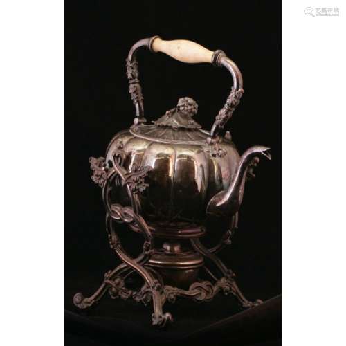 A Silver And Bronze Kettle