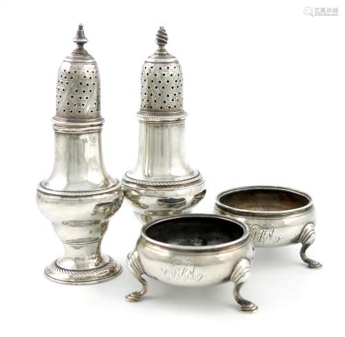 Two similar George III silver pepper pots, by Thomas Daniell, London 1774 and 1775, circular bellied