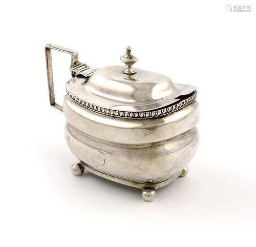 A George III silver mustard pot, marks worn, London 1810, rounded rectangular form, scroll handle,