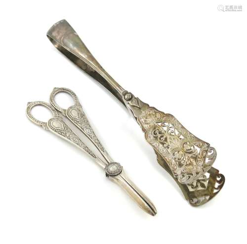 A pair of Victorian silver serving tongs, by E. Hutton, London 1885, pierced and engraved blades,