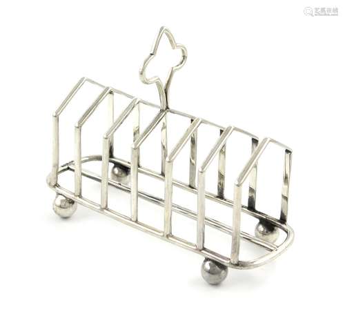 A late-Victorian silver seven bar toast rack, by Mappin and Webb, Sheffield 1900, with Gothic arched