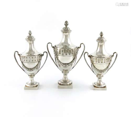 A suite of three George III silver sugar vases and covers, by Thomas Heming, London 1774, urn