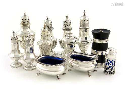 A mixed lot of silver condiments, various dates and makers, comprising: a George III pepper pot,