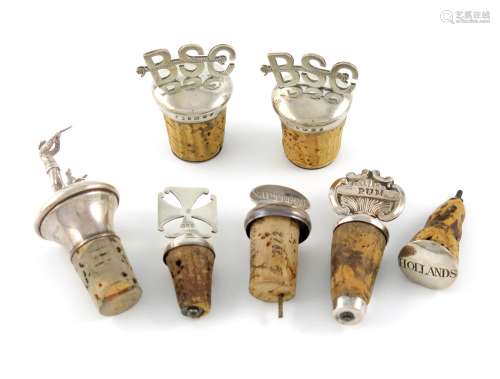 A small mixed lot of bottle stoppers, comprising silver examples: a modern one modelled as a game