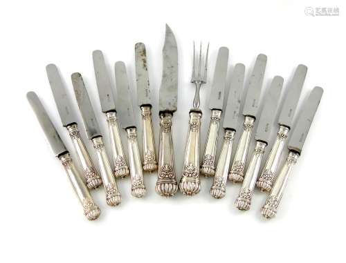 A set of twelve continental silver table knives and a carving knife and fork, fluted terminals, with