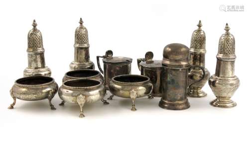 A mixed lot of silver condiments, various dates and makers, comprising: a set of four pepper pots,