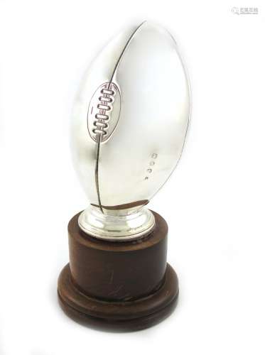 An Irish silver rugby ball trophy, maker's mark partially worn, Dublin 1997, plain form on a