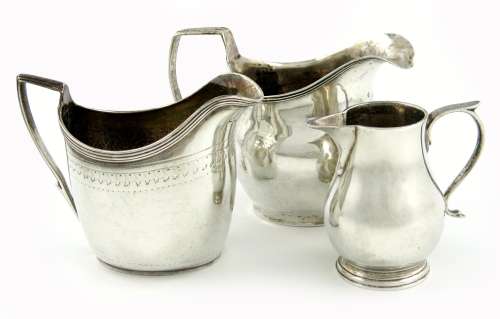 A mixed lot of three silver cream jugs, comprising: a George III provincial one, by Joseph Hicks, of