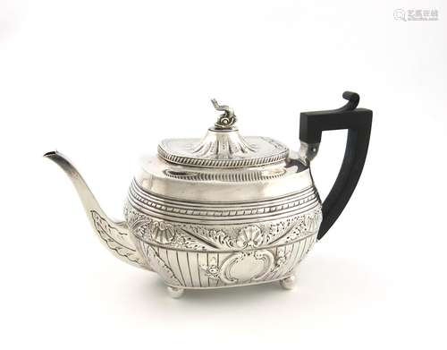 A Victorian silver tea pot, by Charles Stuart Harris, London 1889, oblong bellied form, embossed