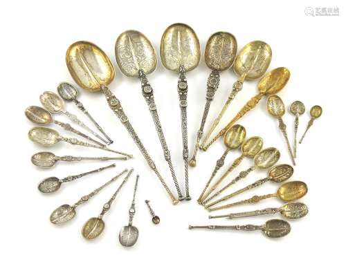 A large collection of silver and silver-gilt anointing spoons, various dates and makers, comprising: