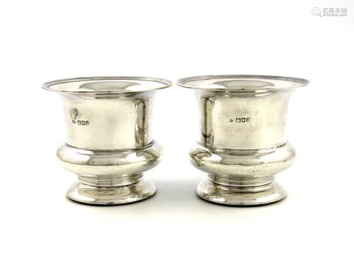 A pair of Edwardian silver vases / coasters, by William Comyns, London 1905, campana form, reeded