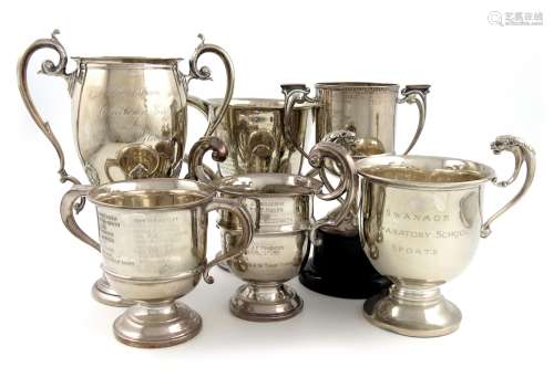 A mixed lot of five silver trophy cups, comprising one with cut card decoration, by S. Blanckensee