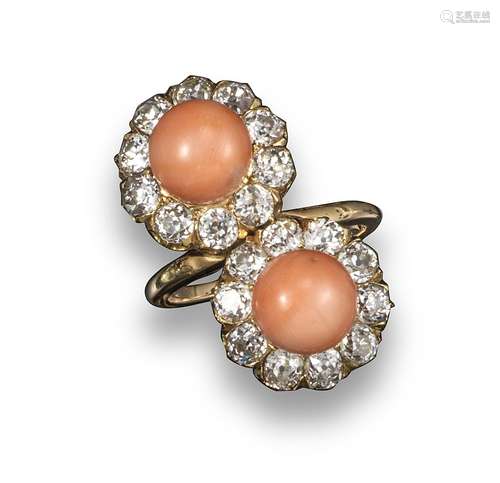 A double coral bead and diamond cluster ring, each coral set within a surround of cushion-shaped