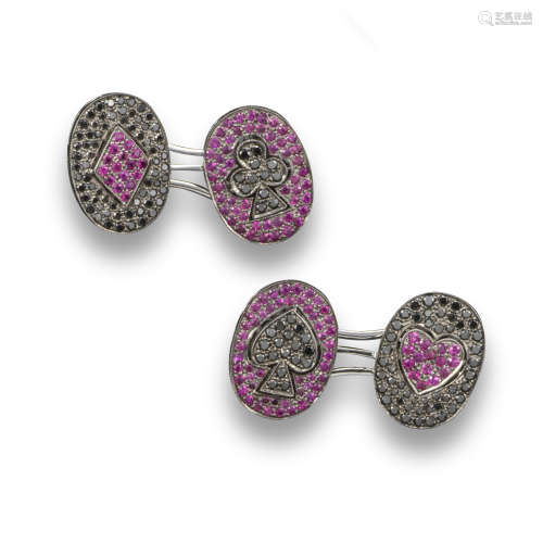A pair of white gold cufflinks depicting the four suits, pave-set with black diamonds and rubies,