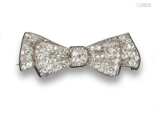 An early 20th century diamond bow brooch, the stylised bow is pave-set with diamonds in platinum,