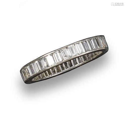 A diamond full-circle eternity ring, the forty-one baguette-shaped diamonds weigh approximately 2.