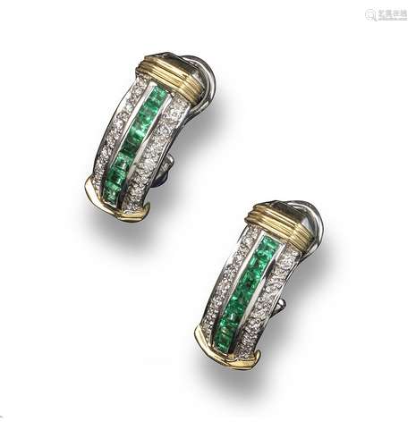 A pair of emerald and diamond half-hoop earrings, each set with a central line of calibré-cut