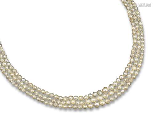 A three-row natural and cultured pearl necklace, the openwork gold and silver clasp millegrain-set