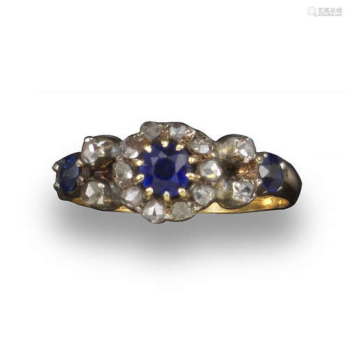 A Victorian sapphire and diamond cluster ring, the circular-cut sapphire is set within a surround of