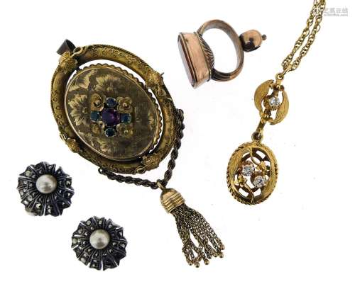A diamond-set gold pendant, on a twisted-link gold chain, a Victorian gold pendant set with emeralds