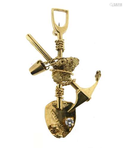 A gold miner's brooch, designed as a crossed pick-axe and shovel, centred with a gold nugget,
