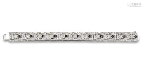 An Art Deco style onyx and diamond bracelet, each panel millegrain set with onyx cabochons within