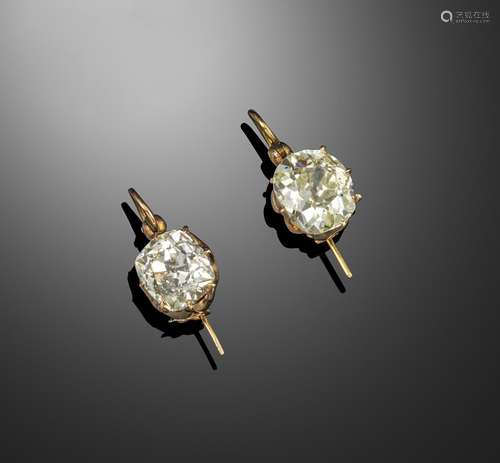 A pair of diamond earrings, the old cushion-shaped diamonds weigh 5.75 and 5.67cts, set in yellow