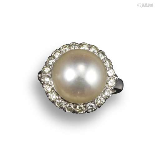 A cultured pearl and diamond cluster ring, the button-shaped pearl measures 11.6mm and set within