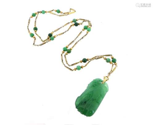 A carved and pierced jade pendant on a gold chain, suspending from a gold fancy-link neck chain with