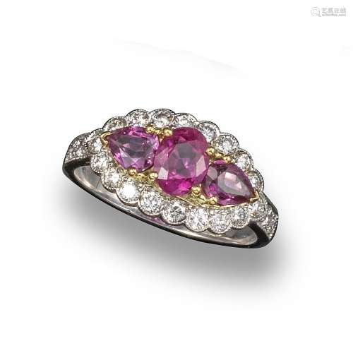A ruby and diamond cluster ring, the oval-shaped ruby weighs approximately 0.80cts, set with two